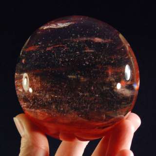 You are considering a beautiful cherry quartz sphere with a hematite 