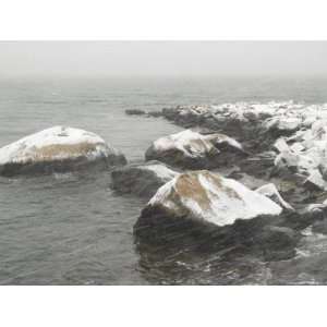  Snow Blowing in the Wind Over the Rocks on the Shore of a 