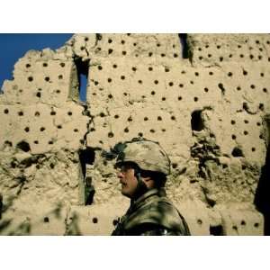 Canadian and Afghan National Army Soldier Walk Along a Destroyed Grape 