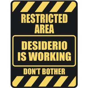   RESTRICTED AREA DESIDERIO IS WORKING  PARKING SIGN 