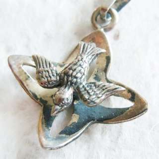   of this religious charm pendant it s the descending dove flying above