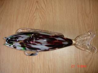 This is a vintage glass fish.Made in white,red and green color glass 