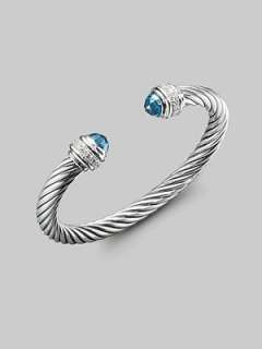   silver, capped with faceted blue topaz and banded with pavé diamonds
