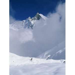  Man Hiking Down from Annapurna Base Camp into the Clouds 