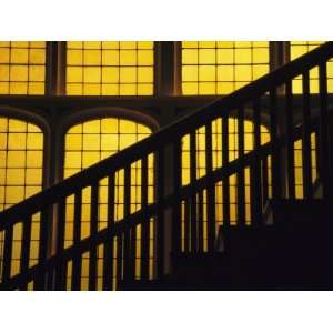  A Staircase in Silhouette against a Yellow Stained Glass 